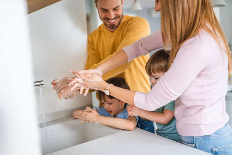 family washing hands hygiene