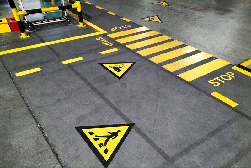 Bright yellow line marking in industrial warehouse.