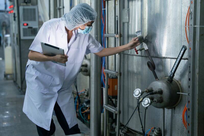 Food auditor checking facility machines
